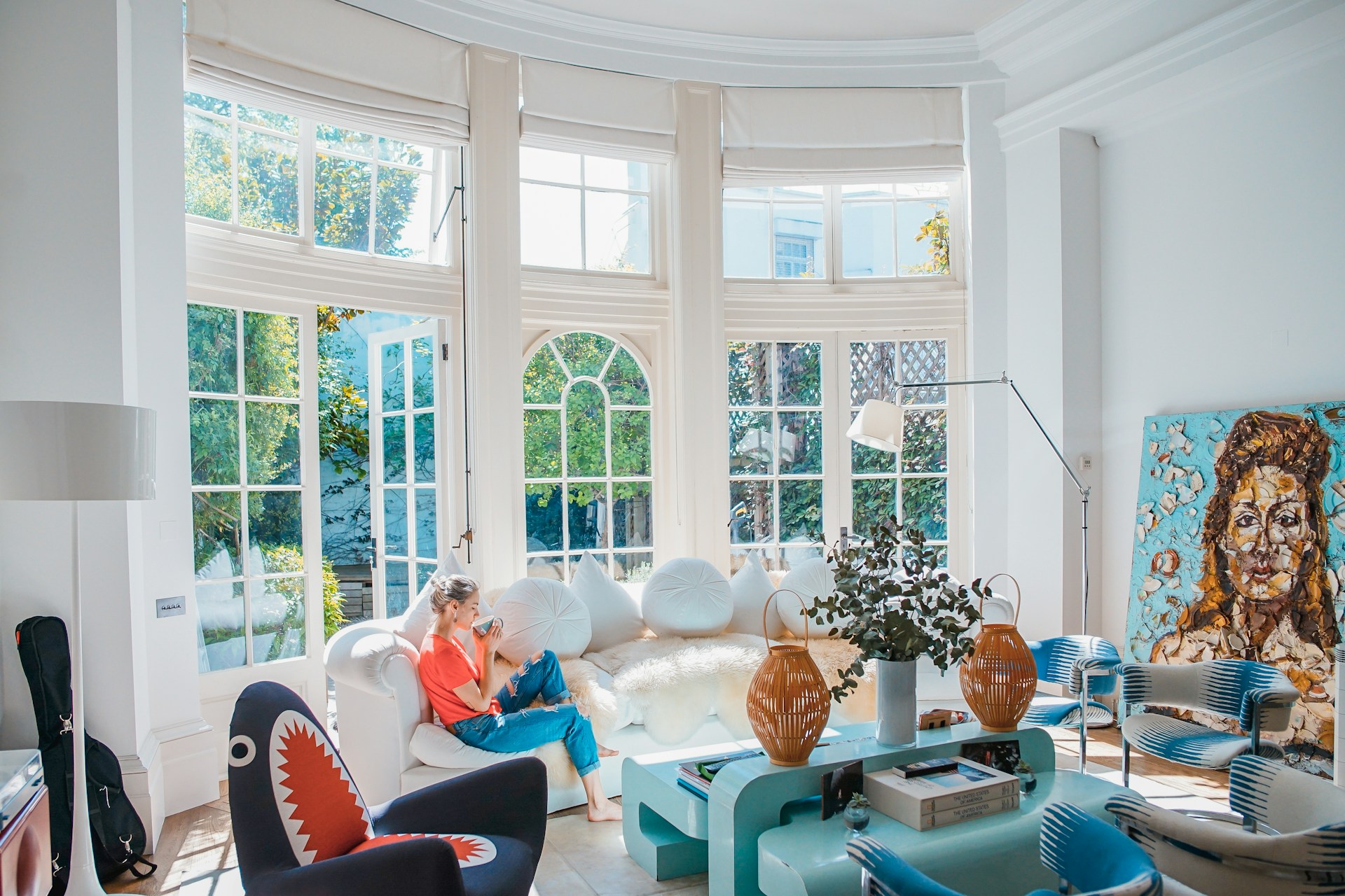 woman-sitting-on-white-couch-near-window